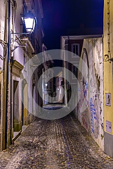 Night view of a narrow street at the old town of Coimbra, Portugal