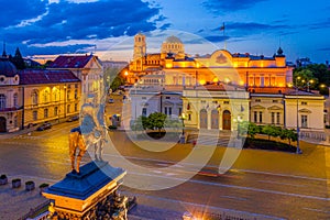 Night view of the National Assembly of the Republic of Bulgaria and Alexander Nevski cathedral in Sofia. Sign translates - Unity