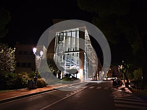 Night view of the National Council (Conseil National) of Monaco located in a modern building.