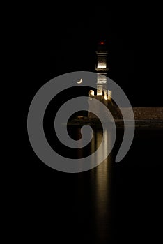 Night view of the old lighthouse at Chania harbor in Crete