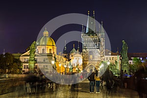 Night view of  Old Town Bridge Tower and background of  Church of St Francis Seraph at the bank of River Vltava, view from the