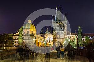 Night view of  Old Town Bridge Tower and background of  Church of St Francis Seraph at the bank of River Vltava, view from the photo