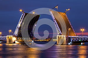 Night view on open Palace Bridge and Neva River