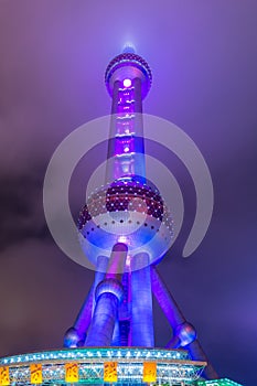 Night view of the The Oriental Pearl Tower at a cloudy day after raining with colorful  light in Pudong, Shanghai, China