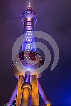 Night view of the The Oriental Pearl Tower at a cloudy day after raining with colorful  light in Pudong, Shanghai, China