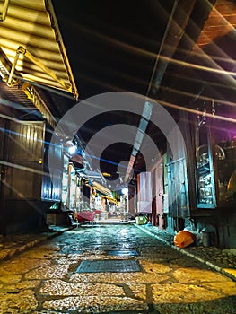 Night view of oriental style market street in Sarajevo, Bosnia. Empty street with cozy lights and closed shops around
