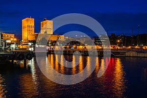 Night view of Oslo city hall facing the harbor and Oslofjord, Oslo, Norway