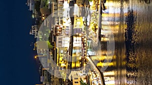 Night view over Lake Voulismeni at Agios Nikolaos, island of Crete, Greece - timelapse, zoom out, tilt