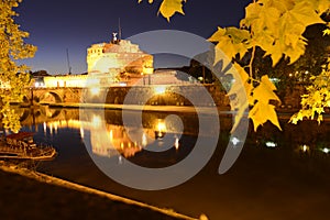 Night view over the Tevere river and the Sant'Angelo castle and bridge photo