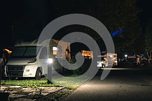 Night view of the parking lot for a motorhome, camper van, campsite camp for sleeping and relaxing. vacation and travel tour