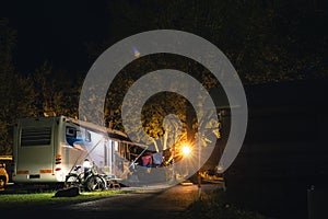 Night view of the parking lot for a motorhome, camper van, campsite camp for sleeping and relaxing. vacation and travel tour