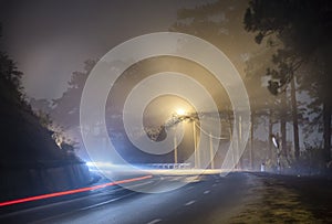 The night view of the pass road is full of fog with magical street lights