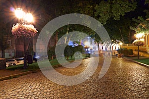 Night view of Primorsky boulevard in Odessa city, Ukraine. Beautiful city Park and street illumination, walking people photo