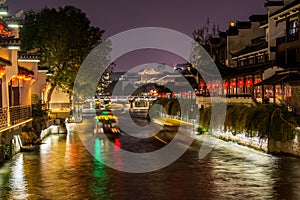 Night view of Qinhuai River and historic buildings at the riverbank near Fuzimiao Confucius Temple in Nanjing, China