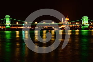 night view of the renovated chain bridge over the Danube river in Budapest.