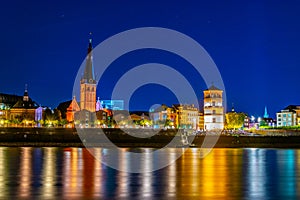 Night view of riverside of Rhein in Dusseldorf with Saint Lambertus church, Germany