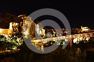 Night view on rocky river bank Jucar and bridge in Cuenca. Casti photo