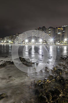 Night view of sea rocks with the background of Pitangueiras Beach
