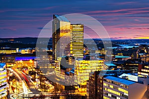 A night view of Sentrum area of Oslo, Norway, with modern and historical buildings and car traffic