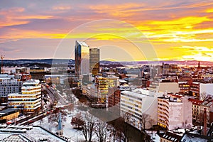A night view of Sentrum area of Oslo, Norway, with modern and historical buildings and car traffic