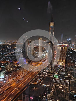 Night view of the skyline of modern city of skyscrapers- Dubai. Lights from the roads and buildings in the dark.