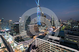 Night view with skyscraper in business district in Bangkok Thailand. Light show at Magnolias Ratchaprasong in Bangkok, Thailand.