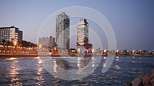 Night view of skyscrapers from port - center of nightlife at Barcelona