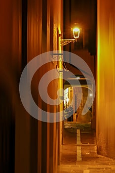 Night view with small street in Trieste, Italy