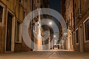 Night view of a small street in Venice, Italy. Architecture and sights of Venice. Nightlife in Venice. Venetian postcard