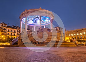 Night view of the square called Plaza del Castillo with the typical kiosk illuminated, Pamplona photo