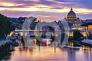 Night view at St. Peter`s cathedral with river in Rome, Italy