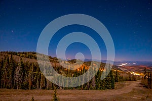 Night view of stars over the city in the horizont in Bryce Canyon National Park photo
