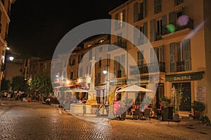 Night view of street with shops in Vence.