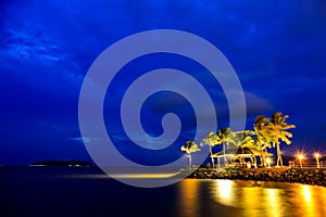 Night view of sunset bar at tropical beach.