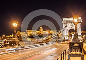 Night view of the Szechenyi Chain Bridge over Danube River and Royal Palace in Budapest