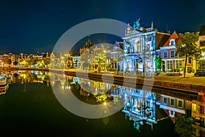 Night view of Teylers museum situated next to a channel in the dutch city Haarlem, Netherlands