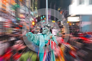 Night view of the Times Square street with street artists and huge crowd with motion blur effect