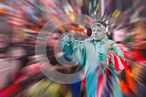 Night view of the Times Square street with street artists and huge crowd with motion blur effect