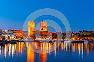 Night view of town hall in oslo viewed behind the port, Norway