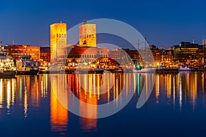 Night view of town hall in oslo viewed behind the port, Norway