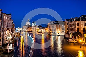 Night view of typical canal and gondolas in Venice, Italy.