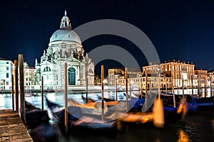 Night view of typical canal and gondolas in Venice, Italy.
