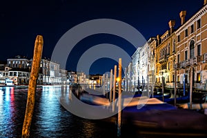 Night view of typical canal and gondolas in Venice, Italy.