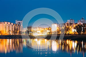 Night View Of Urban Residential Area Overlooks To City Lake Or River