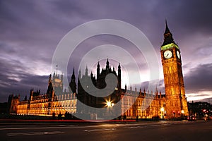 Night view of Westminster Palace over dramatic cloudy sky