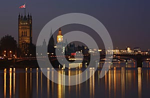 Night view of Westminster Palace over illuminated Thames River