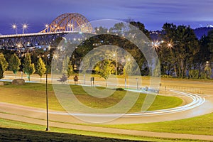 Night view of a winding road leading to a bridge