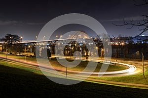 Night view of a winding road leading to a bridge