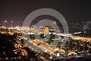 The night view of Xi`an city includes the Big Wild Goose Pagoda, urban tall buildings and ancient buildings.