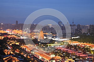 The night view of Xi`an city includes the Big Wild Goose Pagoda, urban tall buildings and ancient buildings.
